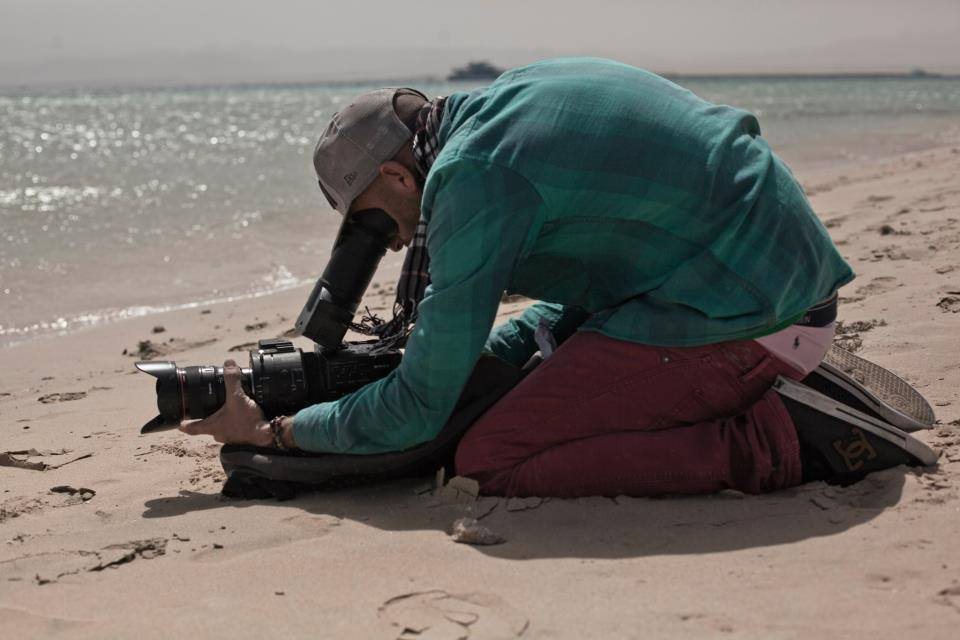 Camera operator shooting on the beach